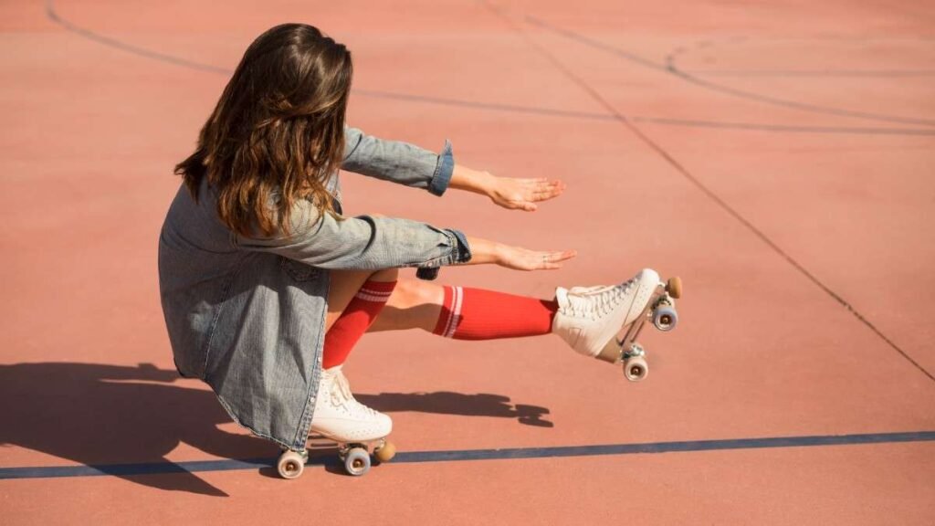 Woman performing a one-legged crouch trick on quad skates. Is roller skating good exercise It improves balance.